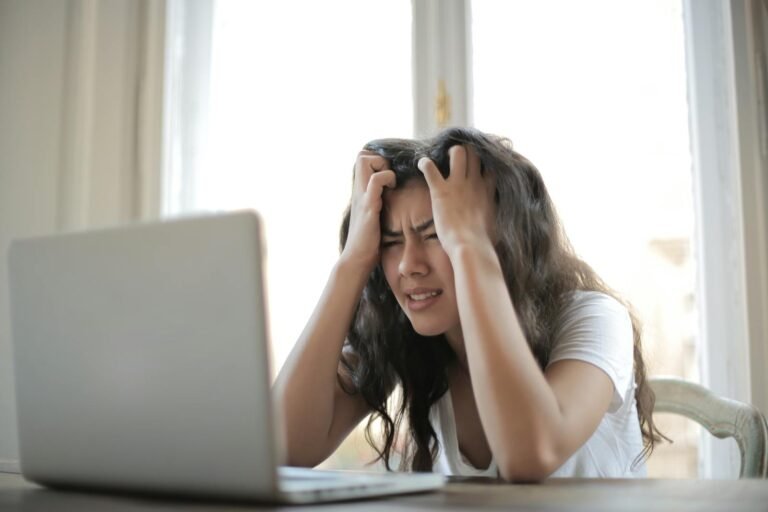 Woman in White Shirt Showing Frustration, Are we overworking ourselves to death